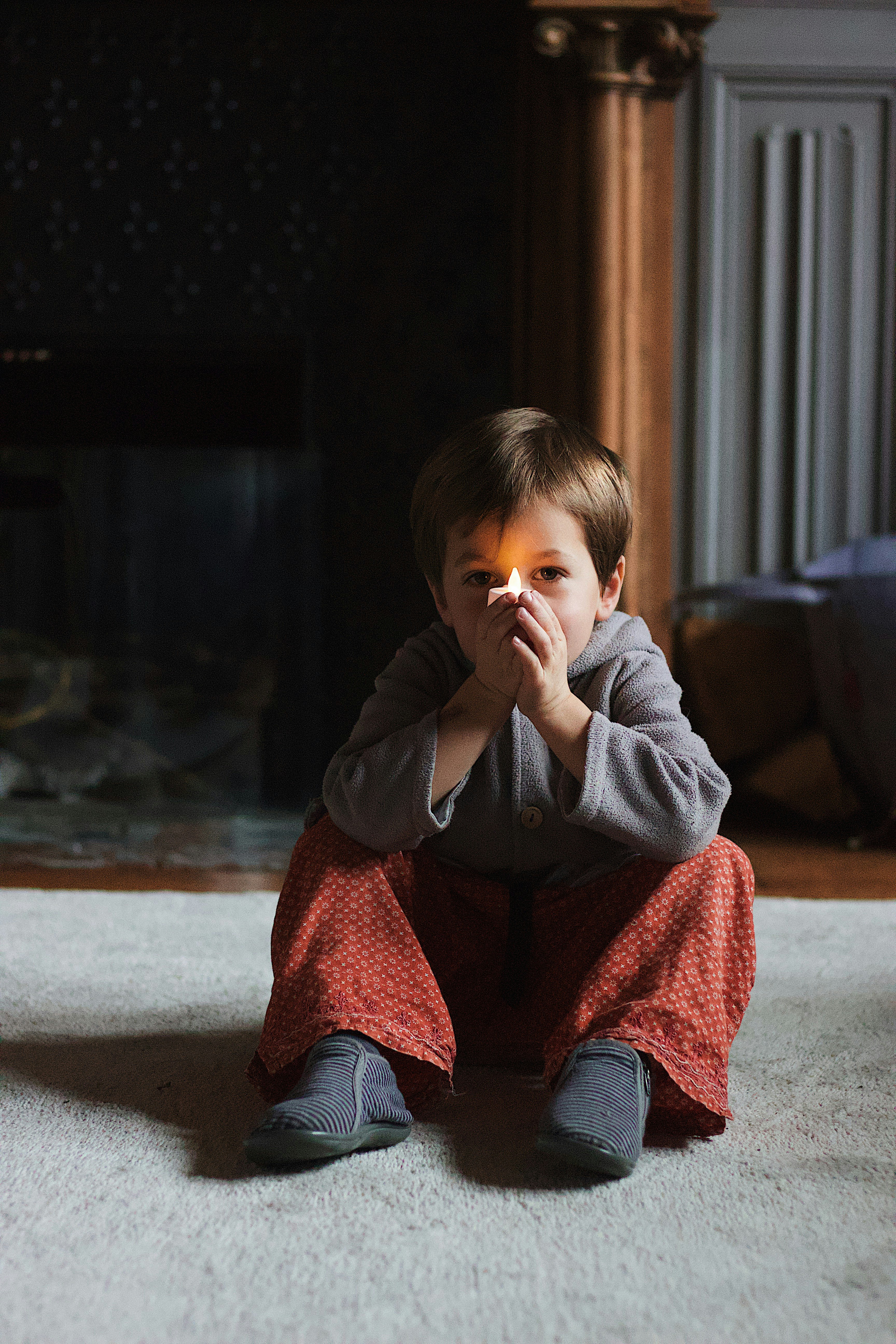 boy holding a lighted tealight